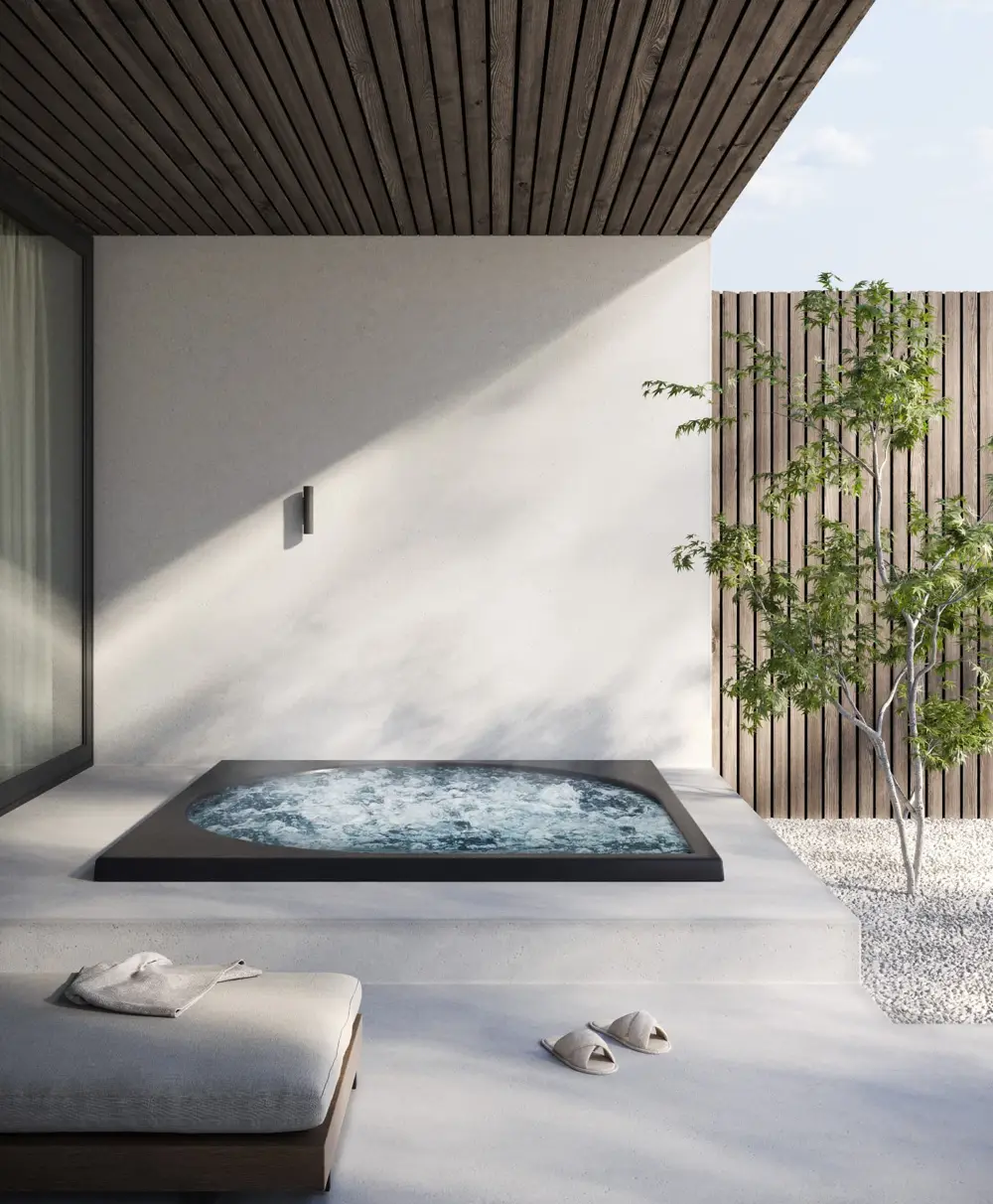 Drop Design Spa, nedsänkt svart bad under tak med vit vägg