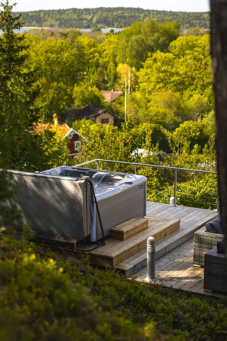 HotSpring Limelight spabad på trädäck med utsikt över skog och sjö
