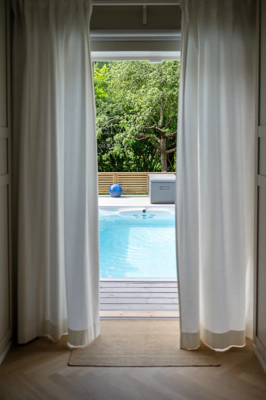 USSPA swimspa sett inifrån huset genom öppna dörrar en sommardag